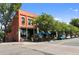 Charming two-story building with inviting storefronts, vibrant awnings, and cozy outdoor seating at 6088 Quail Ct, Arvada, CO 80004