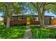 Charming brick home with a well-maintained lawn and a welcoming yellow front door at 6088 Quail Ct, Arvada, CO 80004