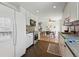 Bright kitchen featuring white cabinets, stainless appliances, and an open dining area at 6088 Quail Ct, Arvada, CO 80004