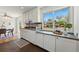 Bright kitchen features white cabinets, dark countertops, blue tile backsplash, and stainless steel appliances at 6088 Quail Ct, Arvada, CO 80004