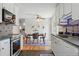 Stylish kitchen with white cabinets, stainless appliances, and open view to the dining area at 6088 Quail Ct, Arvada, CO 80004