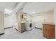 Bright laundry room featuring tile floors, a washer, dryer and cabinet storage at 6088 Quail Ct, Arvada, CO 80004