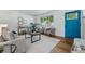 Bright living room with hardwood floors, stylish furniture, and a blue front door at 6088 Quail Ct, Arvada, CO 80004