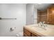 Bathroom featuring wood cabinet, neutral vanity, and shower with glass door at 7865 E Mississippi Ave # 1102, Denver, CO 80247