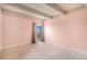 Bedroom with pink walls, neutral carpet, and a window with a view at 7865 E Mississippi Ave # 1102, Denver, CO 80247