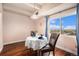 Elegant dining room features hardwood floors, a round table, and a picturesque window view at 7865 E Mississippi Ave # 1102, Denver, CO 80247