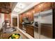 Well-lit kitchen featuring stainless steel appliances, granite countertops, and custom wood cabinetry at 7865 E Mississippi Ave # 1102, Denver, CO 80247