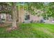 A view of the backyard with grass, foliage, and sliding glass doors at 1534 S Ouray Cir # B, Aurora, CO 80017