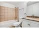 Tiled bathroom features a bathtub with shower and a granite vanity at 1534 S Ouray Cir # B, Aurora, CO 80017