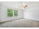 Spacious bedroom with natural light from a large window and neutral carpet flooring and ceiling fan at 1534 S Ouray Cir # B, Aurora, CO 80017