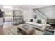 Stylish living room and bar area with open concept layout, hardwood floors, and plenty of natural light at 1534 S Ouray Cir # B, Aurora, CO 80017