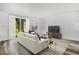 Bright living room featuring hardwood floors, large windows, and a comfortable seating area with modern decor at 1534 S Ouray Cir # B, Aurora, CO 80017