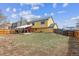 Spacious fenced backyard featuring a large lawn, covered patio, and yellow home exterior at 10241 Routt St, Broomfield, CO 80021