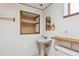 Bathroom with pedestal sink and open shelving at 10241 Routt St, Broomfield, CO 80021