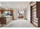 Dining room with sliding doors to the deck, an open kitchen, and natural light at 10241 Routt St, Broomfield, CO 80021