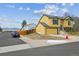 Charming yellow home with blue accents, a two-car garage, and manicured front yard landscaping at 10241 Routt St, Broomfield, CO 80021