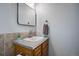 Well-lit bathroom featuring a modern sink, updated countertop and a stylish rectangular mirror at 14590 E 2Nd Ave # B309, Aurora, CO 80011