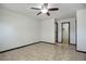 This bedroom features neutral paint, tile flooring, a ceiling fan, and a closet at 14590 E 2Nd Ave # B309, Aurora, CO 80011