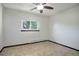 Inviting bedroom featuring a ceiling fan, window and neutral walls with tile flooring at 14590 E 2Nd Ave # B309, Aurora, CO 80011