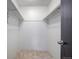A closet is pictured with tile flooring, white paint, shelving and a dark-stained door at 14590 E 2Nd Ave # B309, Aurora, CO 80011