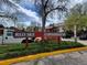 Exterior shot of the Red Sky Condominiums showing the signage out front with spring foliage at 14590 E 2Nd Ave # B309, Aurora, CO 80011