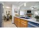 Kitchen featuring stainless steel appliances and a view into the dining and living rooms at 14590 E 2Nd Ave # B309, Aurora, CO 80011