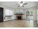 Bright living room with a fireplace, sliding glass doors to a balcony, and tile floors at 14590 E 2Nd Ave # B309, Aurora, CO 80011