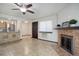 Bright living room featuring a fireplace, a ceiling fan, and a view into the kitchen and entry way at 14590 E 2Nd Ave # B309, Aurora, CO 80011