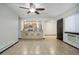 Open living space with ceiling fan, tile flooring and kitchen in the background at 14590 E 2Nd Ave # B309, Aurora, CO 80011