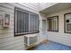 Private porch with security bars on the windows, and a welcome mat at the front door at 14590 E 2Nd Ave # B309, Aurora, CO 80011