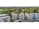 Aerial view showcases the condo buildings, lush trees, parking areas and the surrounding neighborhood at 1308 Snowberry Ln # 303, Louisville, CO 80027