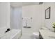 Bathroom featuring a white tub, tiled walls, and modern fixtures, ensuring a bright and clean space at 1308 Snowberry Ln # 303, Louisville, CO 80027