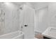 Bright bathroom featuring a tiled shower, white tub, and modern fixtures at 1308 Snowberry Ln # 303, Louisville, CO 80027