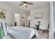Bright bedroom featuring a ceiling fan, light wood floors, and seating area at 1308 Snowberry Ln # 303, Louisville, CO 80027