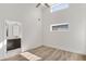 Bedroom with hardwood floors connecting to bathroom that has white countertops and dark cabinets at 1308 Snowberry Ln # 303, Louisville, CO 80027