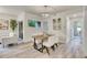 The dining area features a modern chandelier, a view to the outdoors and seamlessly connects to the living area at 1308 Snowberry Ln # 303, Louisville, CO 80027