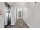 Hallway with gray patterned carpet leading to the exit door and the elevator at 1308 Snowberry Ln # 303, Louisville, CO 80027