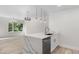 Kitchen island with white cabinets, a sink, and modern lighting over a hardwood floor at 1308 Snowberry Ln # 303, Louisville, CO 80027