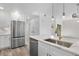 Spacious kitchen with stainless steel appliances and white cabinets with access to a door at 1308 Snowberry Ln # 303, Louisville, CO 80027