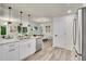 Bright kitchen features stainless appliances, modern fixtures, and an open layout to the dining area at 1308 Snowberry Ln # 303, Louisville, CO 80027