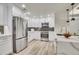 Modern kitchen featuring stainless steel appliances, white cabinets, granite countertops, and stylish tile backsplash at 1308 Snowberry Ln # 303, Louisville, CO 80027