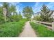 Landscape with grassy path leading into the community at 1308 Snowberry Ln # 303, Louisville, CO 80027