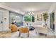Comfortable living room boasts a modern decor, ample natural light, gray accent wall, and wood floors at 1308 Snowberry Ln # 303, Louisville, CO 80027