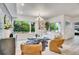 Inviting living room features large windows, modern lighting, stylish furniture and view of the verdant surroundings at 1308 Snowberry Ln # 303, Louisville, CO 80027