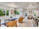 Bright, open-concept living and dining area with modern decor, hardwood floors, and large windows overlooking lush greenery at 1308 Snowberry Ln # 303, Louisville, CO 80027