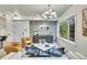 Bright living area with modern furniture, stylish decor, accent wall, and a large window framing the outdoor view at 1308 Snowberry Ln # 303, Louisville, CO 80027