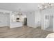 Spacious living space and kitchen with bar, modern lighting, and white cabinets at 1308 Snowberry Ln # 303, Louisville, CO 80027