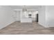 Open-concept living space with light wood floors, modern lighting, and white cabinets at 1308 Snowberry Ln # 303, Louisville, CO 80027