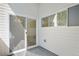 Outdoor patio with white plank walls, gray floors, and sliding door access to interior space at 1308 Snowberry Ln # 303, Louisville, CO 80027