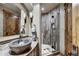 Bathroom featuring a stone sink and a glass shower at 300 Little Sallie Barber Trl, Breckenridge, CO 80424
